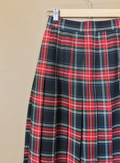 "Authentic vintage pleated plaid skirt. High waisted and longer in length. Waistband has elastic on each side for added comfort. Button and zipper closure in back. Skirt is in excellent, like new, clean condition with very little to no signs of previous wear. Measurements (taken zipped or buttoned up and laid comfortably flat) x2 inches Willow Ridge Tag Size 6P Made in USA Waist 25\"-27\" Hips 38\" Length 31\" All items are free of rips, tears, holes, and stains. Vintage items are subject to sig Preppy Plaid Mini Skirt For School, Plaid Skirted Skort For School, School Uniform Plaid Skort, Fitted Plaid Tennis Skirt For School, School Uniform Plaid Skort For School, Plaid School Uniform Skort, Preppy Pleated Plaid Skort, Preppy Plaid Pleated Skort, Plaid Pleated Skort For School Uniform