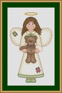 an angel holding a teddy bear in front of a cross stitched picture frame with green trim