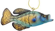 a blue and yellow fish shaped ornament hanging from a gold chain