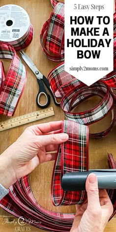 someone using scissors and tape to make a holiday bow on a table with plaid ribbon