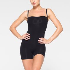 This strapless shortie solution is perfect for cinching your waist, holding in your tummy and core, and smoothing your thighs under mini skirts and dresses. Features pique stitching that supports your bust, an open gusset, and removable adjustable straps that you can wear as shoulder straps, cross back, or as a halter. | SKIMS Strapless Shortie Bodysuit | Black | Seamless Sculpt Strapless Shaping Bodysuit With Built-in Bra, Strapless Stretch Shapewear Bodysuit, Elegant Strapless Smoothing Bodysuit, Strapless Shaping Bodysuit Shapewear, Strapless Shaping Bodysuit, Strapless Shapewear Bodysuit With Built-in Bra, Shapewear Bandeau Bodysuit With Built-in Bra, Fitted Bandeau Bodysuit Shapewear, Fitted Shapewear With Built-in Bra Short Length