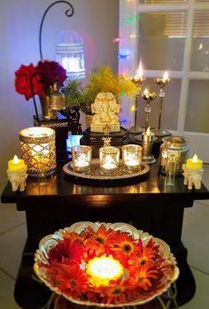 a table topped with candles and plates filled with flowers