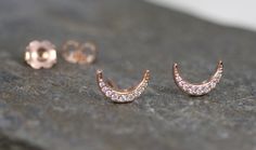 Here is a pair of modern diamond crescent moon studs. I decided to make a pair due to the high demand of my limited antique conversion ones. This pair is in 14k rose gold with pavé set diamond. They include 14k rose gold friction backs. Diamonds Cut: Round Brilliant Cuts Color: G-H Clarity: SI2-I1 Weight: 18 = 0.10 cts Measurements: 1.3 - 0.8 mm Dimensions: 9.6 x 6.4 mm Metal: 14k rose gold Markings: PD and makers mark on one stud Circa: Made to Order Condition Rating: 10 Thanks for looking Elegant Rose Gold Half Moon Jewelry, Elegant Crescent Diamond Earrings, Rose Gold Crescent Earrings, Rose Gold Diamond Earrings, Moon Studs, Gold Diamond Earrings, Diamond Stud Earrings, Diamond Stud, Rose Gold Diamonds