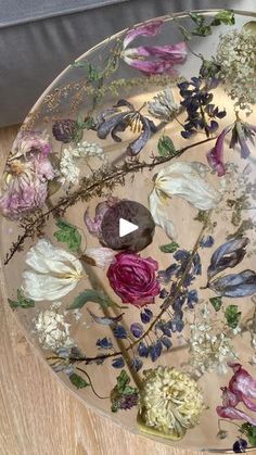 a glass plate with flowers painted on it