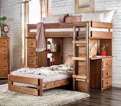 a wooden bunk bed sitting on top of a hard wood floor next to a window