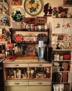 an old fashioned kitchen with many items on the shelves