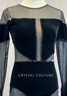 a black bodysuit with sheer sleeves and silver zippers