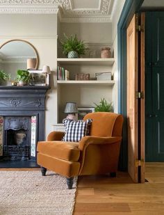 a living room filled with furniture and a fire place next to a fireplace covered in potted plants