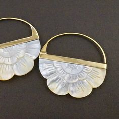 • Hand-carved Pair of Flower Hoop Earrings.• Mother-of-Pearl with gold-tone brass bezel.• 2" drop, 2" diameter hoop.• Backings included. Beautifully hand-carved mother of pearl flowers. Both sides of each earring are carved with the same care and intricacy. All pairs are matched to nicely mirror one another on the ears. The unique organic beauty of each pair of earrings is dazzling. The natural color of mother-of-pearl ranges from bright white to warm antique yellow as seen in photos. Mother of Bohemian Gold Mother Of Pearl Earrings, Handmade White Brass Hoop Earrings, Nickel Free White Brass Hoop Earrings, Nickel-free White Brass Hoop Earrings, White Nickel-free Brass Hoop Earrings, Flower Hoop Earrings, Best Life Ever, Pearl Flowers, Boho Hoop Earrings