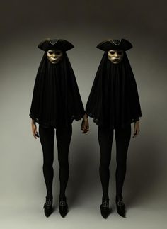 two women dressed in black and white are standing next to each other