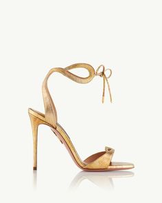 Elevate your warm weather wardrobe with our Tessa Sandals. Crafted in Italy from polished desert metallic calf, the open-toe silhouette features skin-baring loops and slim laces that tie at the ankle for a perfect fit. The pair is balanced upon a pin-thin stiletto heel. Wedding Guest Bags, Bridal Clutch Bag, Aquazzura Heels, Aquazzura Shoes, Footwear For Women, Luxury Footwear, Bridal Bag, Bridal Clutch, Pump Sandals