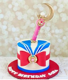 a birthday cake with a pink toothbrush on top and a red ribbon around it