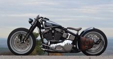 a black and silver motorcycle parked on top of a hill