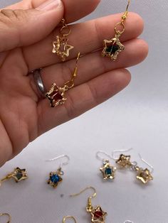 🔹These beautiful 3D star earrings are small and perfect to enhance your look at any time. The earrings are made using hypoallergenic hooks, which are colored silver or gold (randomly selected). The measurements are around 1/2  to 1 inch, including the hook.  🔹You can choose from the colors below:            clear             turquoise             candy apple star             yellowish             🛑 Please be aware that I do not accept cancelations or returns since I am preparing the earrings Gold Star-shaped Crystal Earrings For Party, Metal Drop Earrings With Star Charm, Single Star-shaped Crystal Earring As Gift, Gold Star-shaped Crystal Earrings For Pierced Ears, Nickel-free Star-shaped Earrings For Jewelry Making, Star-shaped Earrings For Pierced Ears As A Gift, Metal Earrings With Star Charm For Gift, Star-shaped Earrings With Lever Back For Gifts, Gold Star Earrings With Ear Wire