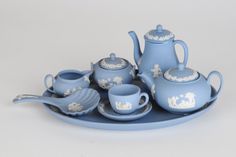 a blue tea set is sitting on a plate