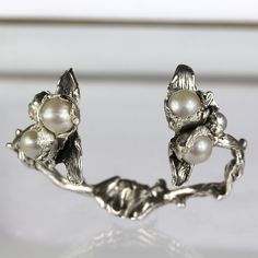 **YOUR PHONE NUMBER IS REQUIRED FOR THE SHIPMENT OF YOUR ORDER so make sure to include it in the ''Note to Seller'' field at checkout. We ship all our orders via DHL to make sure that they are delivered super fast and super safe! ** Our Corallium Silver Pearls cuff bracelet is a solid, hand carved, raw texture bracelet cast in solid sterling silver. Crafted in a chunky, open top design with beautiful floral motifs, inspired by the flowers of the sea, placed at each open end. It is adorned with t Sterling Silver Cuff Bracelet For Anniversary, Unique Oyster Bracelet Jewelry For Anniversary, Silver Sterling Silver Cuff Bracelet, Silver Cuff Bracelet For Anniversaries, Silver Fine Jewelry Cuff Bracelet For Anniversary, Silver Cuff Bracelet For Anniversary, Elegant Hand Cast Jewelry For Anniversary, Anniversary Sterling Silver Cuff Bracelet In White Gold, Unique Sterling Silver Cuff Bracelet For Wedding