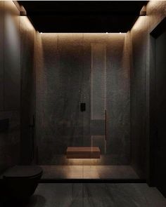 a bathroom with a toilet and some lights on the wall next to it's walls