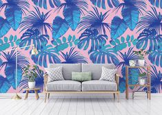 a living room with pink and blue tropical wallpaper