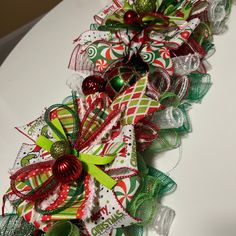 two green and red christmas hair bows on a table