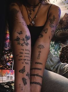 a woman's legs with tattoos on them