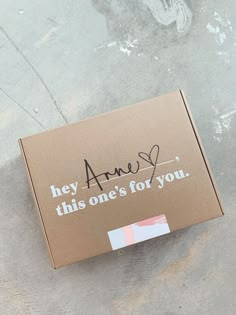 an open box with writing on it sitting on the ground next to a skateboard