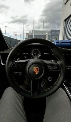 the interior of a porsche car with its steering wheel and dashboard