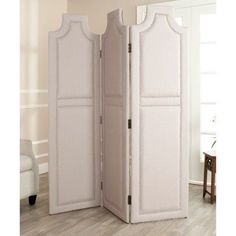 a white room divider with two doors open