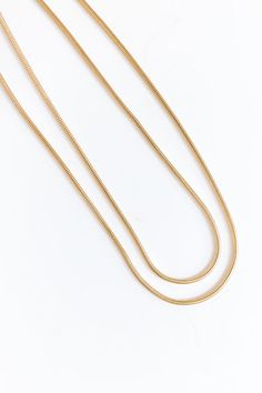 - Layer on the charm with this simply chic necklace! - Gold colored brass material - Two connected chain strands for a layered look - Adjustable length chain and clasp closure - Size: 14.5-17.5 inches Gold Double Chain Charm Necklace For Everyday, Chic Gold Necklaces With Box Chain, Gold Layered Snake Chain Necklace With Adjustable Chain, Everyday Gold Double Chain Charm Necklace, Everyday Gold Delicate Snake Chain Necklace, Chic Gold Necklace With Box Chain, Minimalist Double Strand Gold Chain Necklaces, Gold Double Chain Charm Necklaces, Gold Snake Chain Necklace For Layering