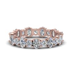 This 3.50 Carat Diamond Eternity Band spectacularly showcases a fine assortment of small scintillating round shaped stones along with the sparkling oval cut diamonds studded in a marvelous prong setting and aligned excellently in a classic alternate pattern accentuating your appeal exquisitely.  Round and oval cut stones of 3.41 Total Carat Weight with Clarity SI2 and Color G in a prong setting. Total Number of Stones:- 22 This 3.50 carat oval shaped and round eternity band is also available with various other choices of precious metals and gemstones too. The eternity band shown is customized as per ring size 7, the carat weight and diamonds will differ slightly as per ring size selected. This prodigious diamond eternity band is available from ring size 4 - 9. Free shipping within USA Luxury Rose Gold Eternity Band Fine Jewelry, Luxury Rose Cut Diamond Eternity Band For Weddings, Luxury Rose Cut Diamond Eternity Band, Round Eternity Band, Finally Engaged, Eternity Diamond Band, Cute Promise Rings, Gents Ring, Wedding Rings Rose Gold