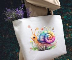 This reusable canvas snail tote bag is versatile enough for any occasion! Use it for books or laptops, a gift or gift bag, take it to the beach, use it for shopping items and overnight stays. These totes make a great gift for you and your loved ones!   *Please visit https://www.etsy.com/shop/ArizonaRocksNCrafts to see more beautiful items! * -All of my tote bags are thick and sturdy with dark blue handles. They are 20.5 inches wide and 14.5 inches tall, so there's plenty of space!  -This item is made to order especially for you and is made with a high-quality heat press. Colors may vary from screen to screen.  -Your bag will be ready to ship in 5 to 7 days and sent via USPS with tracking included. Casual Large Capacity Canvas Bag As Gift, Casual Canvas Tote Bag For Gifts, Casual Tote Canvas Bag As Gift, Casual Canvas Bag For Gift, Casual Canvas Gift Bag, Casual Canvas Softback Bag For Gift, Casual Canvas Softback Bag As A Gift, Casual Softback Canvas Bag For Gift, Casual Softback Canvas Bag As Gift