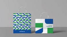 two shopping bags with different designs on them, one is green and the other is blue