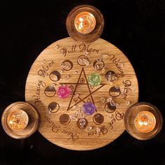 a wooden wheel with seven chakras surrounded by candles