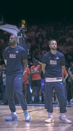 two men standing on top of a basketball court while wearing blue shirts and pants with usa written on them