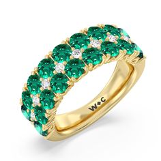 a gold ring with green and white stones on the sides, set in 18k yellow gold