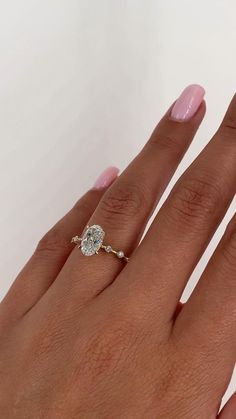 a woman's hand with a diamond ring on it