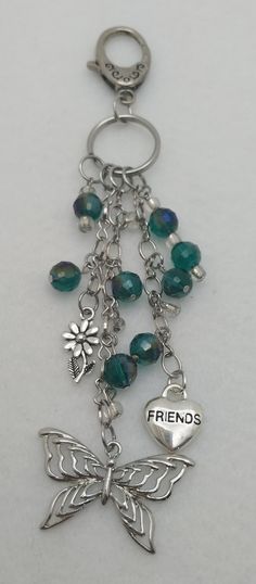 a metal key chain with charms attached to it