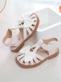 Elevate your little one’s style with our t-strap sandals, designed for elegance and comfort. 	These sandals feature a large, eye-catching bow, making them perfect for dressing up any outfit. 	Available in three classic colors, they are versatile enough for casual outings and special events alike. 	Ideal for any occasion, from park visits to weddings, these sandals will keep your child looking stylish and feeling great. 	Offering both style and functionality, our sandals are the perfect addition to any young girl’s wardrobe. 	Let her step out in confidence and grace with these adorable sandals! Beige Kids, Girls Basketball Shoes, Girls Tennis Shoes, Flower Girl Shoes, Nike Shoes Girls, Toddler Girl Shoes, Baby Sandals, Bow Making, Princess Shoes