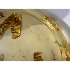 some gold foil is on top of a white plate