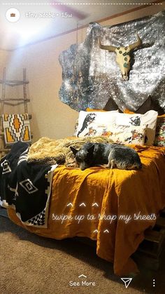 a bed room with a neatly made bed and two dogs sleeping on top of it