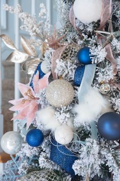 a decorated christmas tree with blue and white ornaments