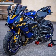 a blue and yellow motorcycle parked on the street