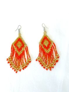 Material: bead Long dangle statement earrings Beaded Chandelier Drop Earrings, Festive Tassel Earrings With Dangling Beads, Festive Dangle Tassel Earrings With Beads, Party Large Beaded Dangle Earrings, Party Dangle Earrings With Large Beads, Orange Beaded Fringe Earrings With Round Beads, Orange Beaded Fringe Drop Earrings, Orange Beaded Earrings With Dangling Beads For Party, Orange Beaded Fringe Jewelry