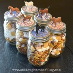 several glass jars filled with different types of candy