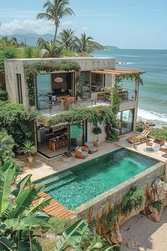 an aerial view of a house with a pool in the foreground and ocean in the background