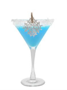 a blue drink in a martini glass with a gold and white decoration on the rim