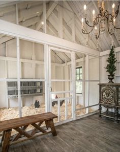 an empty room with a bench in front of the glass doors that lead to another room