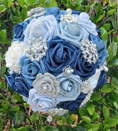 a bridal bouquet with blue roses and crystal brooches