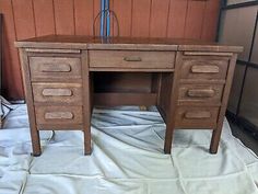 an old wooden desk with three drawers