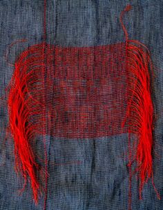 an orange piece of cloth with red thread on it