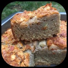 two pieces of bread sitting on top of each other in a metal pan next to grass